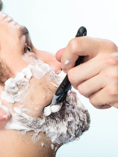 Man shaving with razor