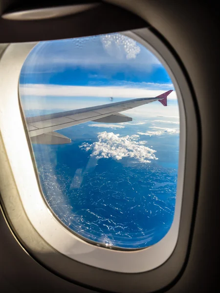 Sky through window of aircraft
