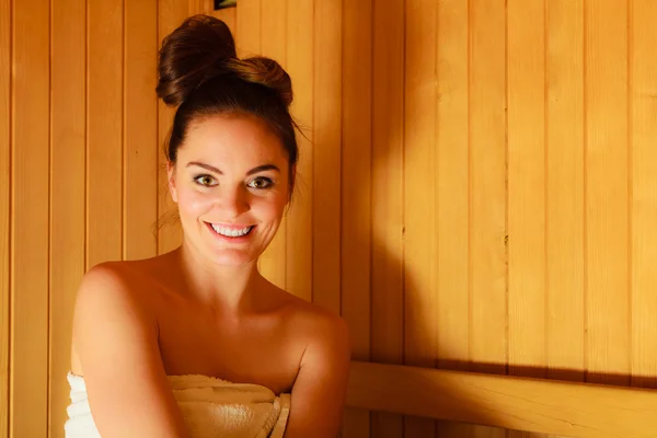 Woman relaxing in sauna