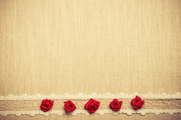 Flowers, lace ribbon on linen cloth.