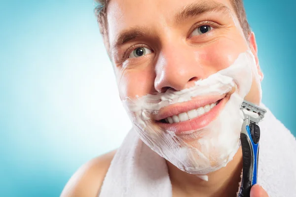 Man shaving using razor