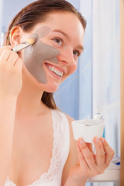 Woman applying mask