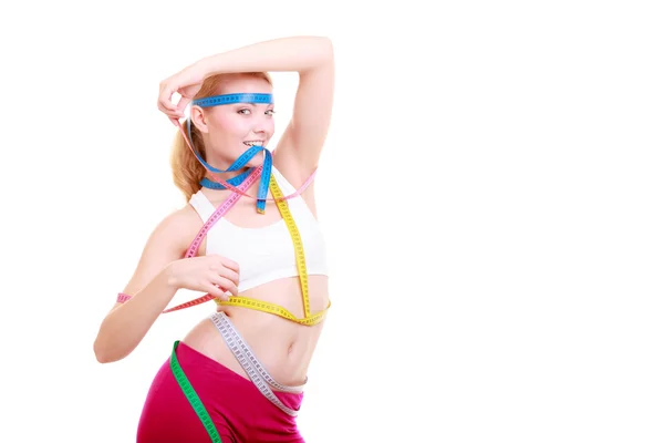 Obsessed fitness woman with a lot of colorful measure tapes