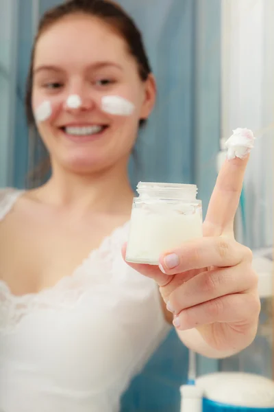Woman with moisturizing skin cream. Skincare.