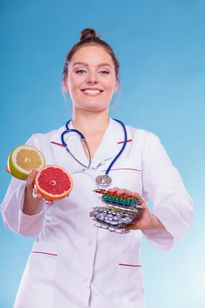 Woman with diet weight loss pills and grapefruits.
