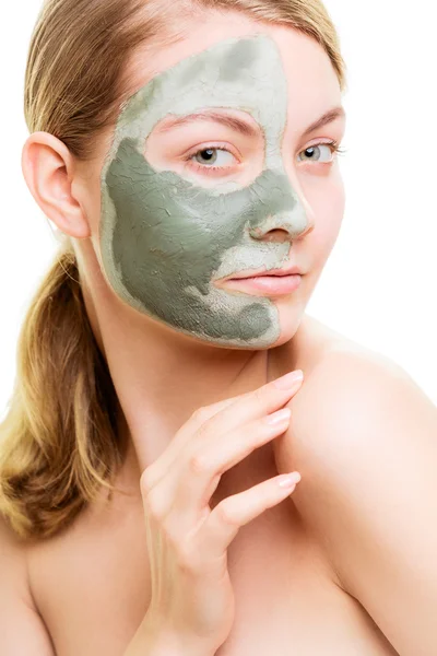 Woman in clay mud mask on face