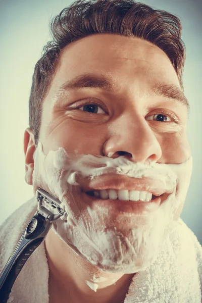 Man shaving using razor