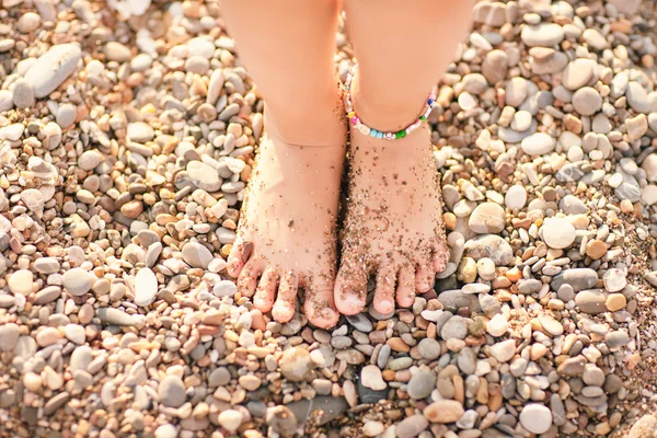 Little girl feet on beach