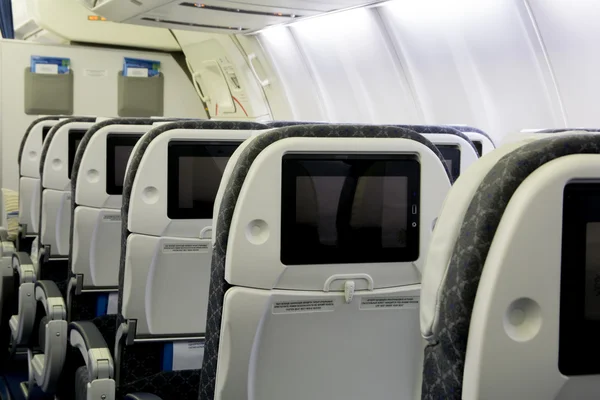 Modern seats in economy class passenger section of aircraft