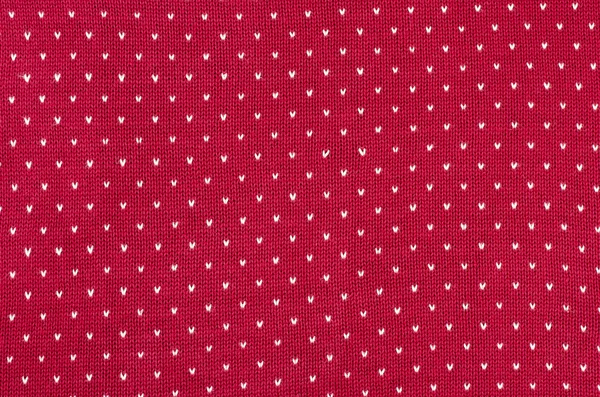 Close up on red and white dots woolen texture.