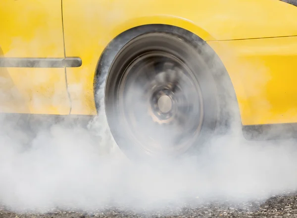 Drag racing car burns rubber off its tires