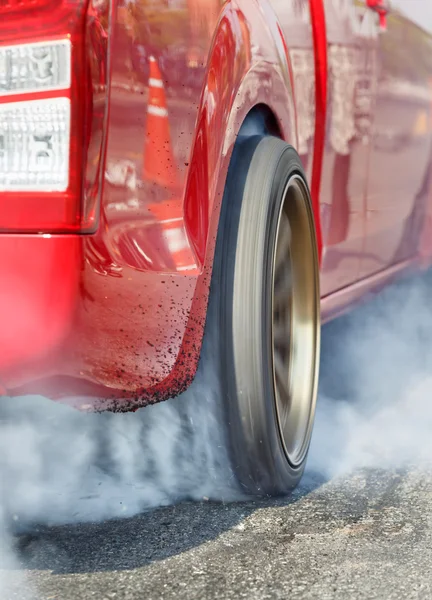 Drag racing car burns  tire in preparation for the race