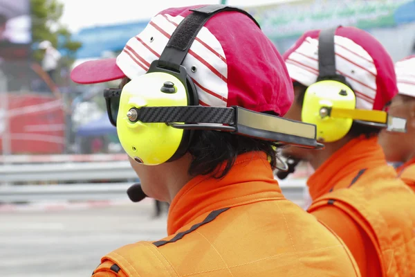 Motor sport rescue team with headphones