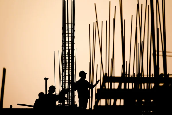 Construction worker silhouette on the work place