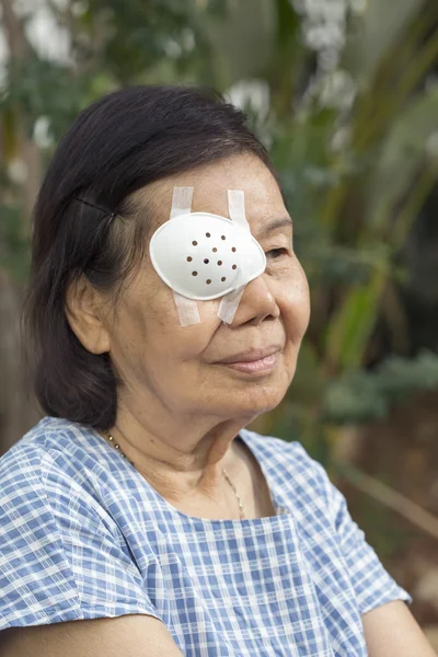 Elderly use eye shield covering after cataract surgery.
