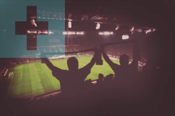 Sport stadium with fans and blending Tonga flag