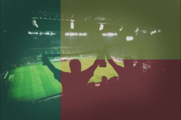 Sport stadium with fans and blending Benin flag