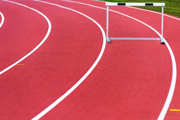 Red race track and hurdle in athletic lines