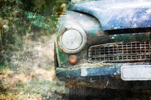 Old Car rusting in forest, damage color vintage photo effect