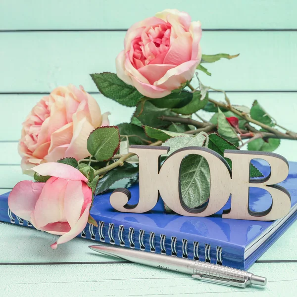 Job text and notebook with roses