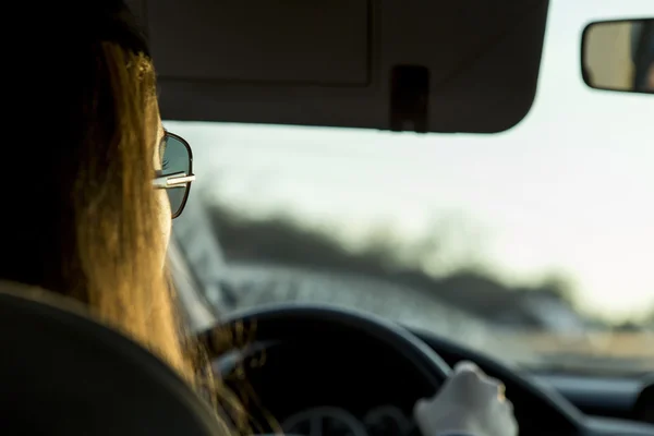 Woman driving, rear view