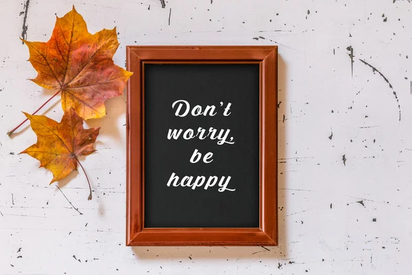 Don\'t worry, be happy text on framed blackboard