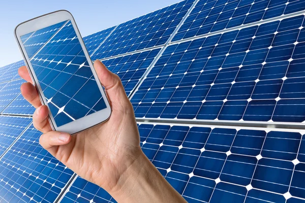 Smartphone in hand showing solar panels