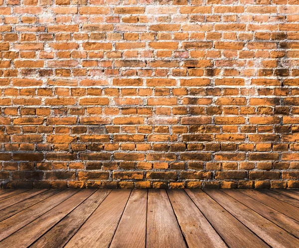 Wood floor with old brick wall background