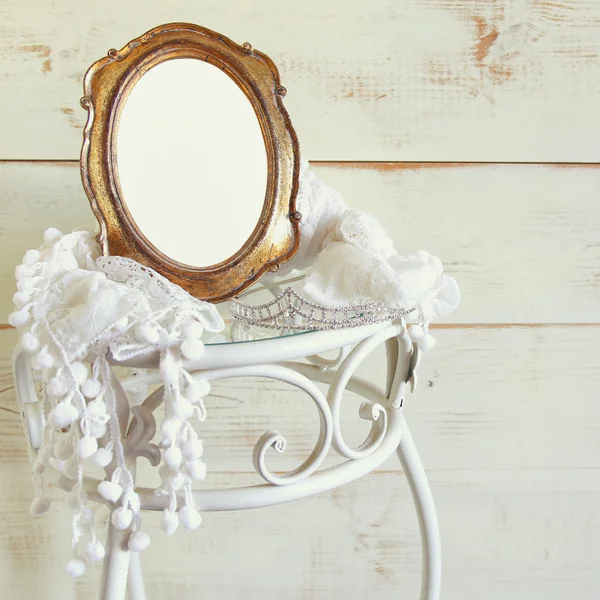 Antique blank vintage style frame and tiara on elegant table. template, ready to put photography. vintage filtered