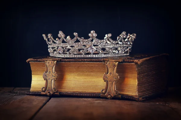 Decorative crown on old book. vintage filtered. selective focus