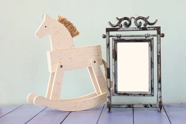 Antique blank vintage style frame and old rocking horse