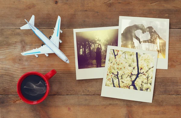 Travel instant photographs next to cup of coffee