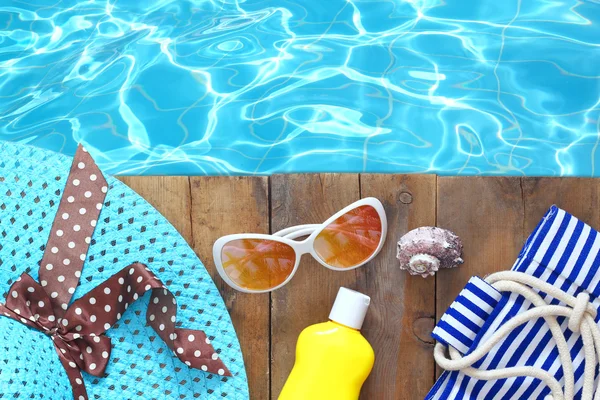 Swimming pool and wooden deck with beach accessories