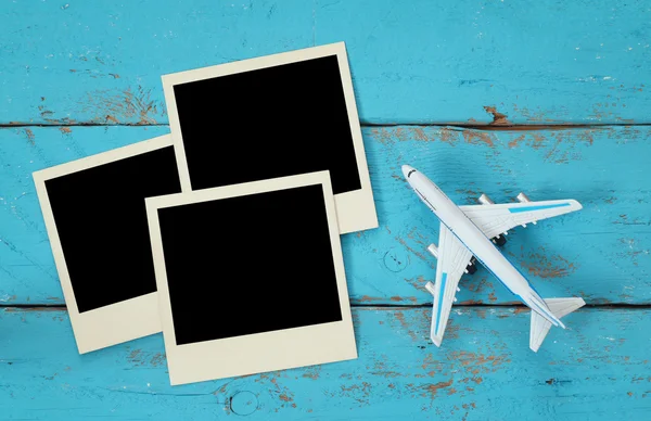 Instant photos next to airplane