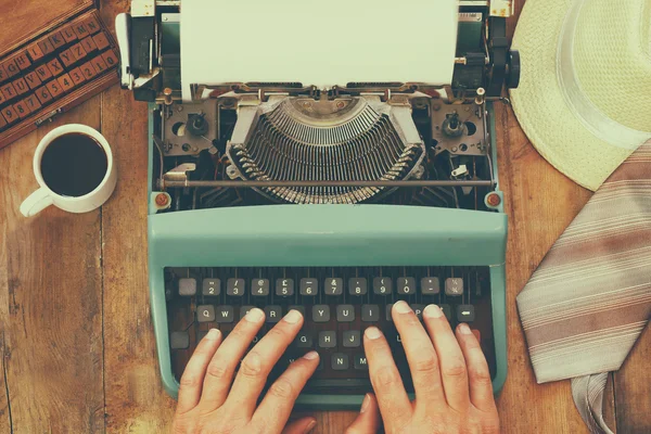 Man typing on vintage typewriter