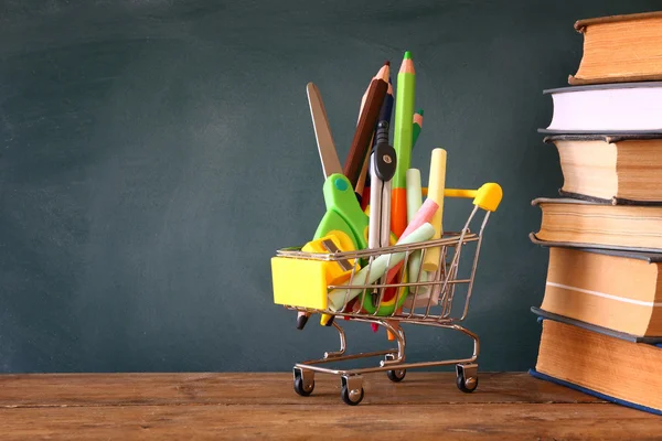 Shopping cart with school supply. Back to school concept