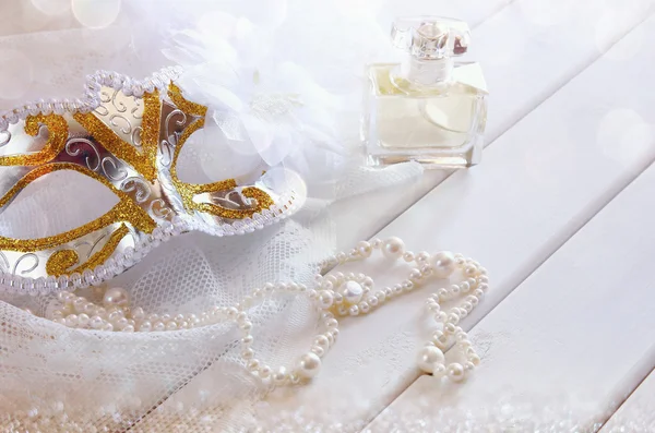 Dreamy photo of Vintage white venetian mask and pearls