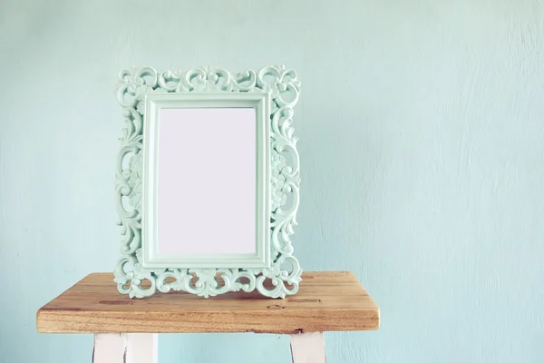 Image of vintage antique classical frame on wooden table