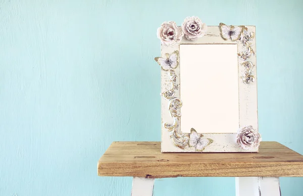 Image of vintage antique classical frame on wooden table