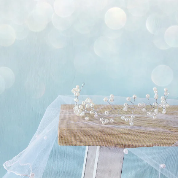 Image of pearls tiara on toilet table. Glitter overlay