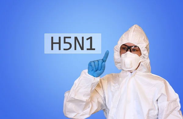 Lab scientist in safety suit drawing word H5N1