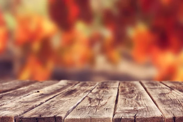 Wooden rustic boards in front of vineyard background in autumn. ready for product display.