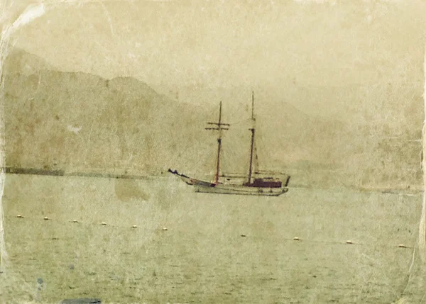 Abstract image of one yacht at open sea. Old style photo.