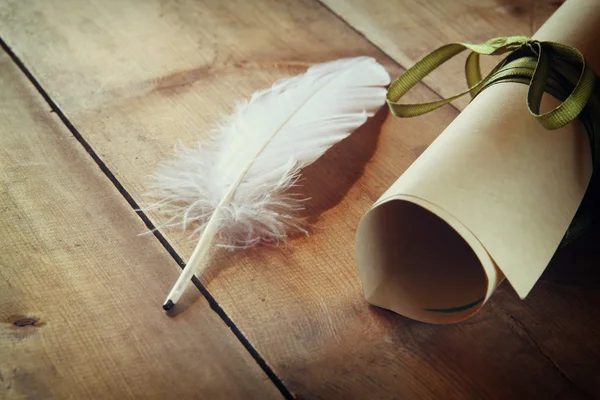 White feather and diploma