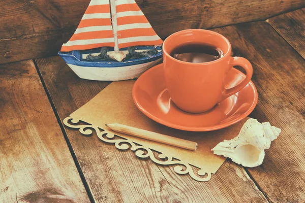 Cup of tea and decorative boat