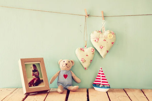 Wooden boat toy and teddy bear
