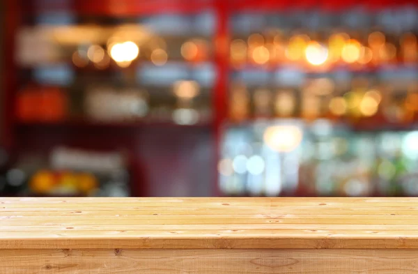 Wooden table in front of abstract background