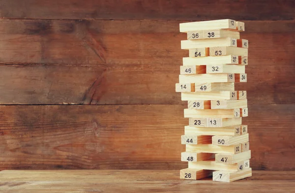 Wooden tower of wooden blocks with numbers on it. planing and strategy concept.