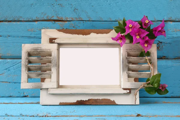 Vintage blank frame next to beautiful purple mediterranean summer flowers. template, ready to put photography