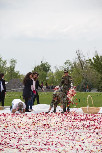 Soldiers assigned to scatter flower petals at the eternal flame of the monument to genocide armyan.Tsitsernakbert. April 27, 2015